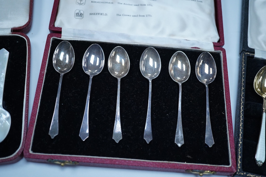 A cased set of six silver gilt and enamel coffee spoons, Adie Brothers, Birmingham, 1966, together with two other cased sets of coffee spoons including a mother of pearl set and a silver set.